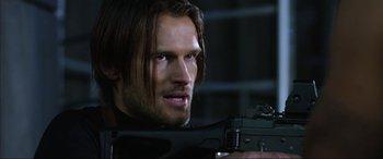 Movie still from “Resident Evil: Retribution” (2012), directed by Paul W.S. Anderson – A person holding a gun; Close Up shot, Over the shoulder angle