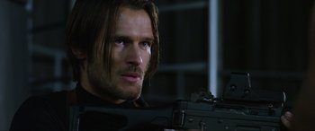 Movie still from “Resident Evil: Retribution” (2012), directed by Paul W.S. Anderson – A person holding a gun; Close Up shot, Over the shoulder angle