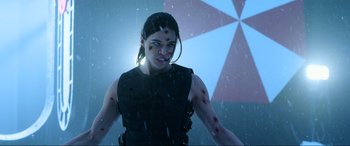 Movie still from “Resident Evil: Retribution” (2012), directed by Paul W.S. Anderson – A woman with blood on her face and shoulder; Close Up shot, Over the shoulder angle