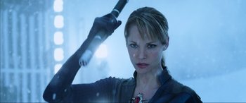 Movie still from “Resident Evil: Retribution” (2012), directed by Paul W.S. Anderson – A woman holding a baseball bat in her hand; Close Up shot, Over the shoulder angle