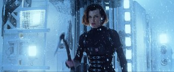 Movie still from “Resident Evil: Retribution” (2012), directed by Paul W.S. Anderson – A woman in a black outfit holding an axe; Medium shot, Low angle