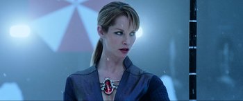 Movie still from “Resident Evil: Retribution” (2012), directed by Paul W.S. Anderson – A woman wearing a necklace with a red heart on it; Close Up shot, Over the shoulder angle
