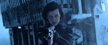Movie still from “Resident Evil: Retribution” (2012), directed by Paul W.S. Anderson – A woman holding a gun in her hand; Close Up shot, Low angle