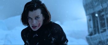 Movie still from “Resident Evil: Retribution” (2012), directed by Paul W.S. Anderson – A woman with a bloody face in the snow; Close Up shot, Low angle