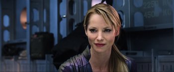 Movie still from “Resident Evil: Retribution” (2012), directed by Paul W.S. Anderson – A woman with long blonde hair wearing a purple shirt; Close Up shot, Over the shoulder angle