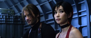 Movie still from “Resident Evil: Retribution” (2012), directed by Paul W.S. Anderson – A man and a woman are standing next to each other; Close Up shot, Low angle