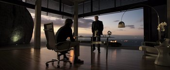 Movie still from “Resident Evil: The Final Chapter” (2016), directed by Paul W.S. Anderson – Two men are standing in front of a table; Wide shot, Low angle