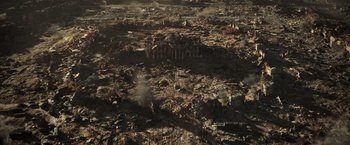 Movie still from “Resident Evil: The Final Chapter” (2016), directed by Paul W.S. Anderson – An aerial view of a destroyed city with smoke coming out of it; Extreme Wide shot, High angle