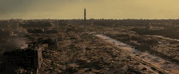 Movie still from “Resident Evil: The Final Chapter” (2016), directed by Paul W.S. Anderson – An aerial view of a city with a tall tower in the background; Extreme Wide shot, High angle