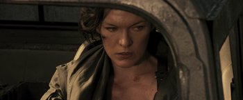 Movie still from “Resident Evil: The Final Chapter” (2016), directed by Paul W.S. Anderson – A person looking at a mirror; Close Up shot, Over the shoulder angle