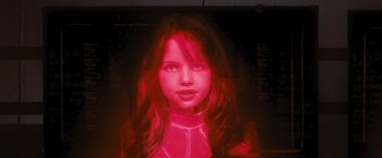 Movie still from “Resident Evil: The Final Chapter” (2016), directed by Paul W.S. Anderson – A young girl is projected onto a computer screen; Close Up shot, Low angle