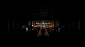 Movie still from “Resident Evil: The Final Chapter” (2016), directed by Paul W.S. Anderson – A man standing in front of a stage in the dark; Extreme Wide shot, High angle