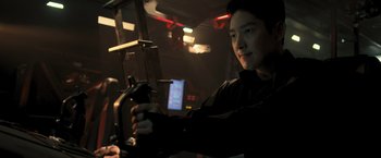 Movie still from “Resident Evil: The Final Chapter” (2016), directed by Paul W.S. Anderson – A man holding a remote control in his hand; Close Up shot, Over the shoulder angle