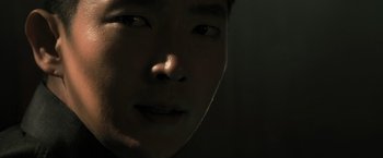Movie still from “Resident Evil: The Final Chapter” (2016), directed by Paul W.S. Anderson – A man's face in the dark; Extreme Close Up shot, Over the shoulder angle