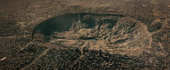 Movie still from “Resident Evil: The Final Chapter” (2016), directed by Paul W.S. Anderson – An aerial view of a large crater in the middle of the desert; Extreme Wide shot, Overhead angle