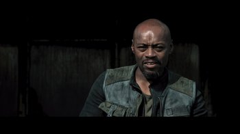 Movie still from “Resident Evil: The Final Chapter” (2016), directed by Paul W.S. Anderson – A man with a beard is looking at the camera; Close Up shot, Low angle