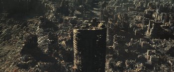 Movie still from “Resident Evil: The Final Chapter” (2016), directed by Paul W.S. Anderson – An aerial view of a destroyed city with a large tower; Extreme Wide shot, High angle