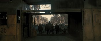 Movie still from “Resident Evil: The Final Chapter” (2016), directed by Paul W.S. Anderson – A group of people standing in front of a building; Wide shot, Low angle