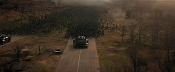 Movie still from “Resident Evil: The Final Chapter” (2016), directed by Paul W.S. Anderson – An image of a car driving down the road in the middle of a field; Extreme Wide shot, High angle