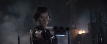 Movie still from “Resident Evil: The Final Chapter” (2016), directed by Paul W.S. Anderson – A woman is pointing a gun at the camera; Medium shot, Low angle
