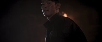 Movie still from “Resident Evil: The Final Chapter” (2016), directed by Paul W.S. Anderson – A man in a black shirt is standing in the dark; Close Up shot, Low angle