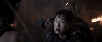 Movie still from “Resident Evil: The Final Chapter” (2016), directed by Paul W.S. Anderson – A woman with blood all over her face and shoulder; Close Up shot, Over the shoulder angle