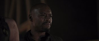 Movie still from “Resident Evil: The Final Chapter” (2016), directed by Paul W.S. Anderson – A man with a beard is looking into the distance; Close Up shot, Low angle