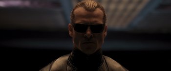 Movie still from “Resident Evil: The Final Chapter” (2016), directed by Paul W.S. Anderson – A person wearing sunglasses; Close Up shot, Low angle