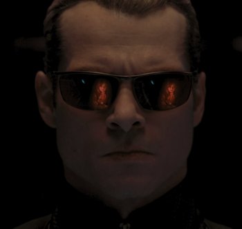 Movie still from “Resident Evil: The Final Chapter” (2016), directed by Paul W.S. Anderson – A person wearing sunglasses; Close Up shot, Low angle