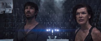 Movie still from “Resident Evil: The Final Chapter” (2016), directed by Paul W.S. Anderson – A man standing in front of a wall of lights; Close Up shot, Over the shoulder angle