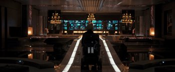 Movie still from “Resident Evil: The Final Chapter” (2016), directed by Paul W.S. Anderson – A man in a wheelchair riding down an escalator; Wide shot, Over the shoulder angle