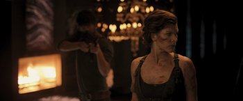 Movie still from “Resident Evil: The Final Chapter” (2016), directed by Paul W.S. Anderson – A woman in a black shirt and a man in a brown shirt; Medium shot, Over the shoulder angle