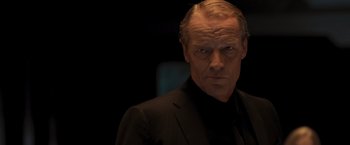 Movie still from “Resident Evil: The Final Chapter” (2016), directed by Paul W.S. Anderson – A person wearing a suit and tie; Close Up shot, Low angle