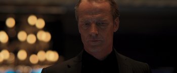 Movie still from “Resident Evil: The Final Chapter” (2016), directed by Paul W.S. Anderson – A person wearing a suit and tie; Close Up shot, Low angle