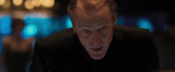 Movie still from “Resident Evil: The Final Chapter” (2016), directed by Paul W.S. Anderson – A person wearing a suit and tie; Close Up shot, Low angle