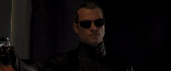 Movie still from “Resident Evil: The Final Chapter” (2016), directed by Paul W.S. Anderson – A person wearing sunglasses; Close Up shot, Low angle