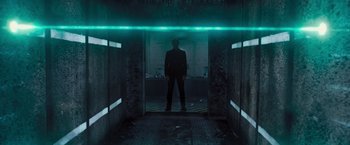 Movie still from “Resident Evil: The Final Chapter” (2016), directed by Paul W.S. Anderson – A man standing in a dark room in front of a mirror; Wide shot, Low angle