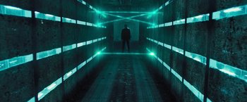 Movie still from “Resident Evil: The Final Chapter” (2016), directed by Paul W.S. Anderson – A man standing in a dark tunnel with green lights; Wide shot, High angle