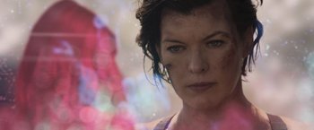 Movie still from “Resident Evil: The Final Chapter” (2016), directed by Paul W.S. Anderson – A woman's face in front of a window; Close Up shot, Over the shoulder angle