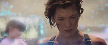 Movie still from “Resident Evil: The Final Chapter” (2016), directed by Paul W.S. Anderson – A person with a gun in their hand; Close Up shot, Over the shoulder angle