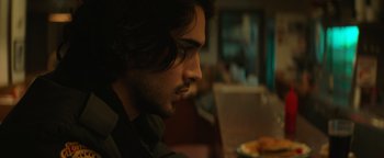 Movie still from “Resident Evil: Welcome to Raccoon City” (2021), directed by Johannes Roberts – A person sitting in front of a laptop; Close Up shot, Over the shoulder angle