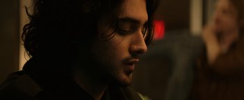 Movie still from “Resident Evil: Welcome to Raccoon City” (2021), directed by Johannes Roberts – A person with long dark hair; Close Up shot, Low angle