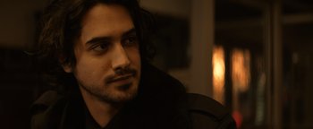 Movie still from “Resident Evil: Welcome to Raccoon City” (2021), directed by Johannes Roberts – A person with long black hair; Close Up shot, Over the shoulder angle