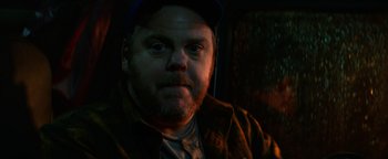 Movie still from “Resident Evil: Welcome to Raccoon City” (2021), directed by Johannes Roberts – A person wearing a hat; Close Up shot, Low angle