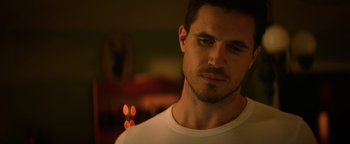 Movie still from “Resident Evil: Welcome to Raccoon City” (2021), directed by Johannes Roberts – A person wearing a white t - shirt; Close Up shot, Low angle