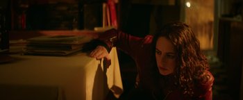 Movie still from “Resident Evil: Welcome to Raccoon City” (2021), directed by Johannes Roberts – A woman sitting in front of a computer monitor; Close Up shot, High angle