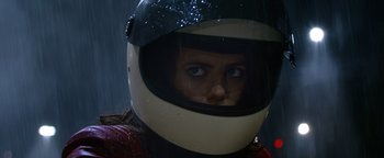Movie still from “Resident Evil: Welcome to Raccoon City” (2021), directed by Johannes Roberts – A person wearing a helmet in the rain; Close Up shot, Low angle