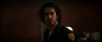 Movie still from “Resident Evil: Welcome to Raccoon City” (2021), directed by Johannes Roberts – A person with long black hair; Close Up shot, Over the shoulder angle