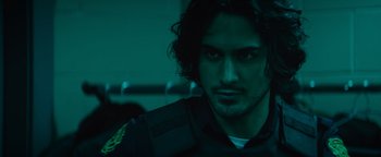 Movie still from “Resident Evil: Welcome to Raccoon City” (2021), directed by Johannes Roberts – A person wearing a black shirt; Close Up shot, Over the shoulder angle