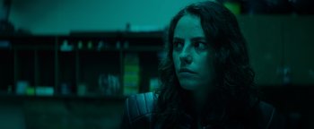 Movie still from “Resident Evil: Welcome to Raccoon City” (2021), directed by Johannes Roberts – A person with long curly hair; Close Up shot, Low angle